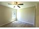 Cozy bedroom featuring neutral carpet, ceiling fan, and a window overlooking the outdoor view at 11609 Sw 59Th Ter, Ocala, FL 34476
