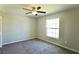Carpeted bedroom with ceiling fan and natural light at 11609 Sw 59Th Ter, Ocala, FL 34476