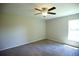 A bedroom features neutral carpet, ceiling fan and great natural light at 11609 Sw 59Th Ter, Ocala, FL 34476