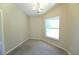 A naturally lit dining room features neutral carpet and a chandelier at 11609 Sw 59Th Ter, Ocala, FL 34476