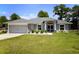 Charming single-story home with a well-manicured lawn and a two-car garage at 11609 Sw 59Th Ter, Ocala, FL 34476
