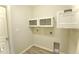 Practical laundry room equipped with shelving and necessary hookups for modern appliances at 11609 Sw 59Th Ter, Ocala, FL 34476