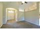 Spacious living room featuring a neutral color scheme, high ceiling, and a ceiling fan at 11609 Sw 59Th Ter, Ocala, FL 34476
