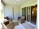 Covered patio providing a relaxing outdoor seating area with sliding glass doors leading inside at 11609 Sw 59Th Ter, Ocala, FL 34476