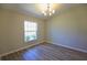 Bright room with wood-look floors, chandelier, and a window providing natural light at 11609 Sw 59Th Ter, Ocala, FL 34476