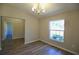 Bright room with wood-look floors, chandelier, and a window providing natural light at 11609 Sw 59Th Ter, Ocala, FL 34476