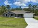 Charming single-story home with a well-manicured lawn and attached two-car garage at 12953 Sw 85Th Pl, Dunnellon, FL 34432