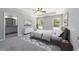 Cozy main bedroom with neutral colors, tray ceiling, and ensuite bathroom at 12953 Sw 85Th Pl, Dunnellon, FL 34432