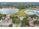 Aerial view of community pool, tennis, playground and lake access at 1317 Ravida Woods Dr, Apopka, FL 32703