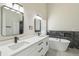 Luxurious bathroom featuring double sink vanity, soaking tub, and elegant fixtures at 1317 Ravida Woods Dr, Apopka, FL 32703