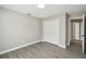 Neutral bedroom featuring durable flooring and double door closet at 1317 Ravida Woods Dr, Apopka, FL 32703