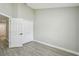 Bright bedroom featuring vinyl floors, closet, neutral color paint and an entry door at 1317 Ravida Woods Dr, Apopka, FL 32703