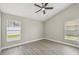 Bright bedroom with gray walls, wood floors, and a ceiling fan at 1317 Ravida Woods Dr, Apopka, FL 32703