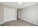 Neutral bedroom featuring durable flooring and double door closet at 1317 Ravida Woods Dr, Apopka, FL 32703