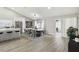 Bright dining room with a modern white table and gray chairs, adjacent to the kitchen and an outdoor patio at 1317 Ravida Woods Dr, Apopka, FL 32703