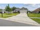 Beautiful home with long driveway, well-kept lawn, and charming exterior is bathed in natural light at 1317 Ravida Woods Dr, Apopka, FL 32703