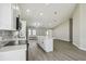 Modern kitchen with a large island, stylish lighting, and sleek appliances, perfect for cooking and entertaining at 1317 Ravida Woods Dr, Apopka, FL 32703