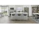Modern kitchen featuring stainless steel appliances, a kitchen island with barstools, and an adjacent dining area at 1317 Ravida Woods Dr, Apopka, FL 32703