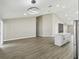 Bright living area adjacent to the kitchen with light hardwood floors and vaulted ceilings with modern light fixture at 1317 Ravida Woods Dr, Apopka, FL 32703