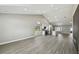 Bright, open-concept living space featuring high ceilings, recessed lighting, and a combined kitchen and living area at 1317 Ravida Woods Dr, Apopka, FL 32703