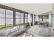 Bright sunroom filled with windows, seating, and small dining area at 1317 Ravida Woods Dr, Apopka, FL 32703