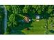 Bird's-eye view of a property with a well-maintained lawn, outbuildings, and mature trees at 13232 Ne 39Th Ter, Anthony, FL 32617