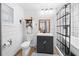 Bright bathroom with white plank walls, a new vanity, modern fixtures, and updated shower at 13232 Ne 39Th Ter, Anthony, FL 32617