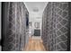 Long bathroom with decorative gray patterned curtains, shelves, toilet, sink and vanity at 13232 Ne 39Th Ter, Anthony, FL 32617