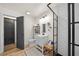 Updated bathroom features a modern shower, white vanity and a charming dark barn door at 13232 Ne 39Th Ter, Anthony, FL 32617