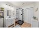 Bright bathroom featuring walk-in shower with glass enclosure and vanity with under cabinet storage at 13232 Ne 39Th Ter, Anthony, FL 32617
