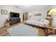 Neutral bedroom features wood floors, TV, a mounted rack, and a comfortable-looking bed at 13232 Ne 39Th Ter, Anthony, FL 32617