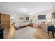 Stylishly decorated bedroom with wood floors, barn door, a desk, and ample natural light at 13232 Ne 39Th Ter, Anthony, FL 32617