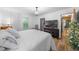 Bedroom features wood floors, a stylish light fixture, ample natural light, and easy access to a large closet at 13232 Ne 39Th Ter, Anthony, FL 32617