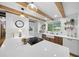 Modern kitchen featuring bright white counters, farmhouse sink, and exposed beam ceiling at 13232 Ne 39Th Ter, Anthony, FL 32617
