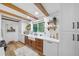 Kitchen features white subway tile backsplash, wood cabinets, floating shelves, and a view to the backyard at 13232 Ne 39Th Ter, Anthony, FL 32617