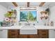Well lit farmhouse sink sits beneath window view of treelined property with decoratively shelved walls at 13232 Ne 39Th Ter, Anthony, FL 32617
