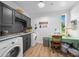 Bright laundry room with ample counter space, modern appliances and a view of the outdoors at 13232 Ne 39Th Ter, Anthony, FL 32617