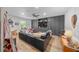 Large living room has comfortable black sofa and built in storage at 13232 Ne 39Th Ter, Anthony, FL 32617