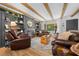 Inviting living room boasts a fireplace, built-in bookshelves, and exposed wood beams at 13232 Ne 39Th Ter, Anthony, FL 32617