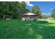 Shed featuring wooden siding, a swing, and chairs on a sunny day at 13232 Ne 39Th Ter, Anthony, FL 32617