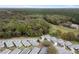 A high angle aerial view of a neighborhood bordered by lush green trees and golf course at 13618 Sw 111Th Cir, Dunnellon, FL 34432