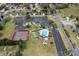 Aerial view of community amenities including a clubhouse, pool, and tennis courts at 13618 Sw 111Th Cir, Dunnellon, FL 34432