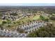 A high angle aerial view of a neighborhood featuring lush green golf course in the distance at 13618 Sw 111Th Cir, Dunnellon, FL 34432