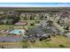 Aerial view of community amenities including a clubhouse, pool, and tennis courts at 13618 Sw 111Th Cir, Dunnellon, FL 34432