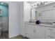Bright bathroom featuring stylish decor, double sinks, white cabinets, with a view of the toilet and shower at 13618 Sw 111Th Cir, Dunnellon, FL 34432