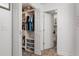 Walk-in closet leading into a bathroom with updated tile floors and fixtures, offering a stylish and functional area at 13618 Sw 111Th Cir, Dunnellon, FL 34432