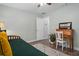 Bright bedroom featuring stylish decor, hardwood flooring, and a hallway view at 13618 Sw 111Th Cir, Dunnellon, FL 34432