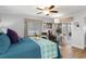 Comfortable bedroom features wood floors, ceiling fan, windows for natural light, and a desk for a home office at 13618 Sw 111Th Cir, Dunnellon, FL 34432
