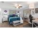Relaxing bedroom features wood floors, ceiling fan, windows for natural light, and a desk for a home office at 13618 Sw 111Th Cir, Dunnellon, FL 34432
