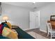 Comfortable bedroom featuring a futon, desk and wood-look flooring at 13618 Sw 111Th Cir, Dunnellon, FL 34432